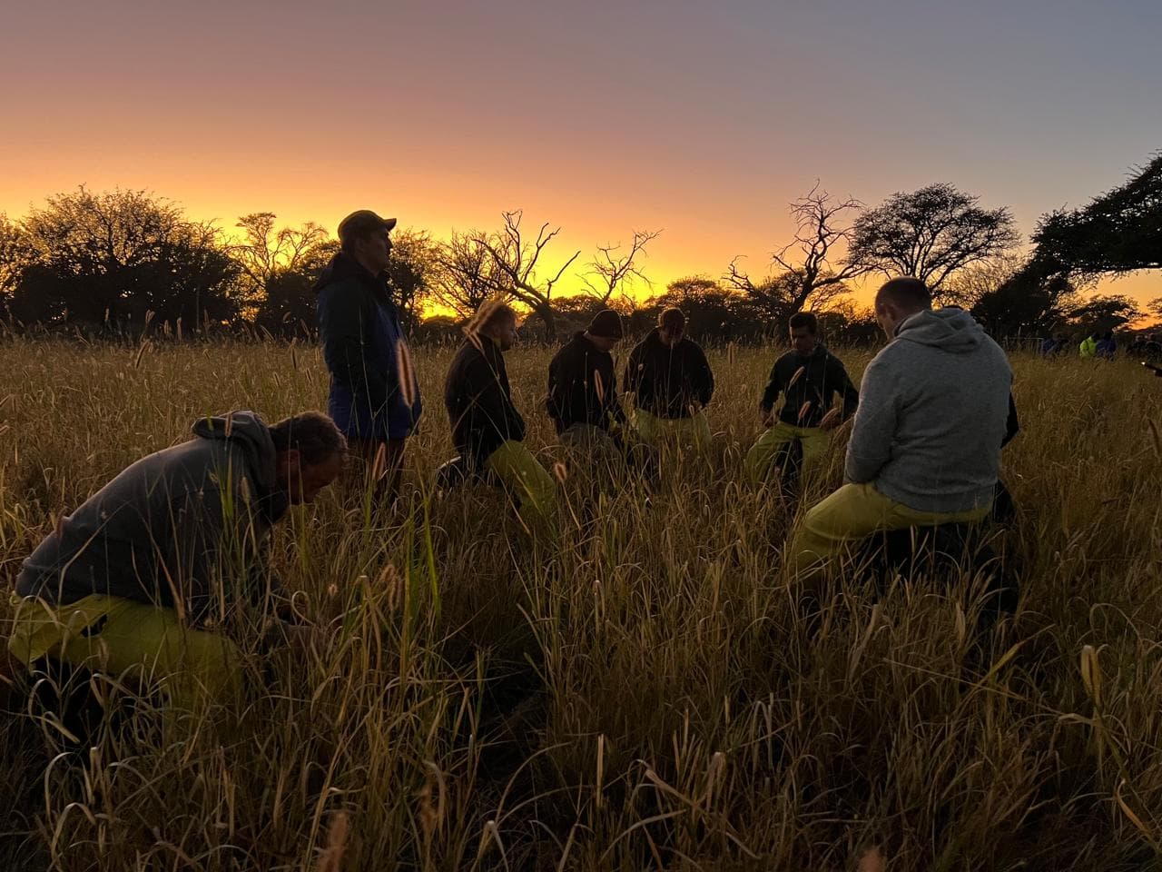 Men gathered around a campfire during a Battle to Fight camp weekend